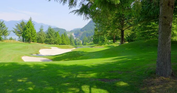 Establishing shot of golf course with gorgeous green and fantastic forest view in Vancouver, Canada, North America. Day time on May 2021. Still camera. ProRes 422 HQ.