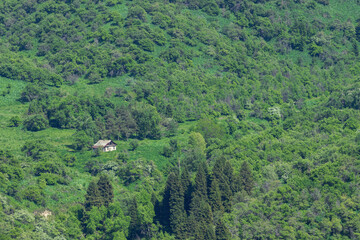 View of the old house on a slope in the mountains