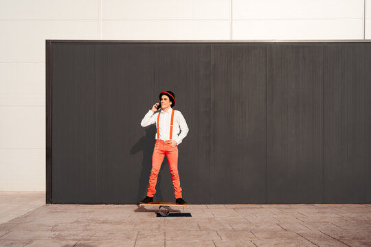 Circus artist on balance board talking on phone