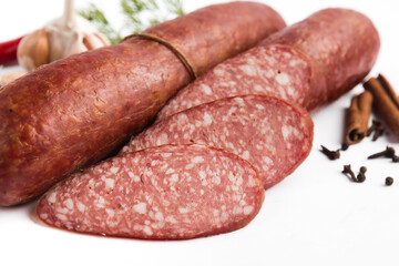 dry-cured salami sausage on a white plate