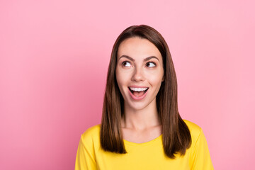 Fototapeta premium Photo of impressed brunette hair millennial lady look empty space wear yellow t-shirt isolated on pastel pink color background
