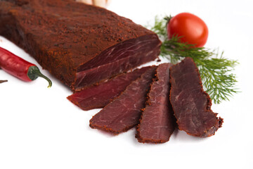 baked smoked piece of basturma on a white plate