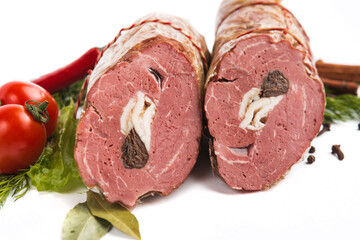 baked smoked meatloaf stuffed with dried fruits on a white plate