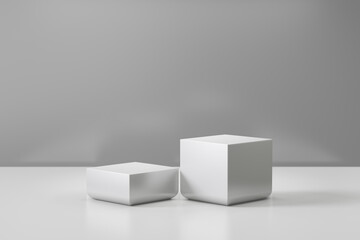 Cosmetic display product stand. Two gray blocks white background. 3D rendering illustration