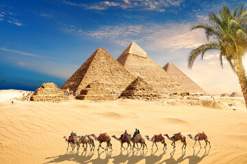 Fototapeta na wymiar Camels in the sands by the Great Pyramids of Giza, Cairo, Egypt