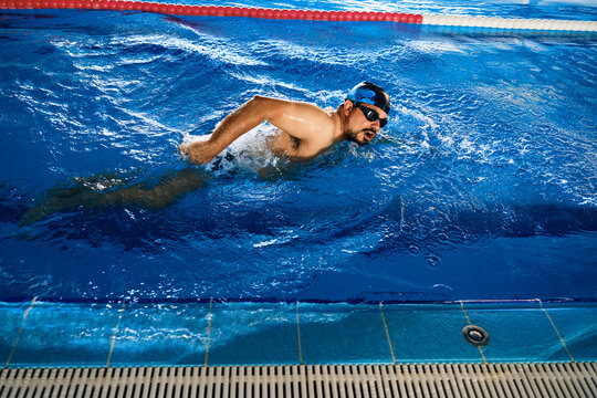 Man swimming in freestyle in pool