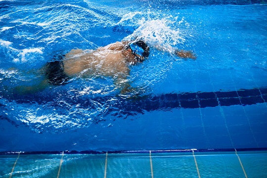Man swimming in freestyle in pool