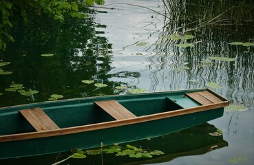 Green canoe boat on the river
