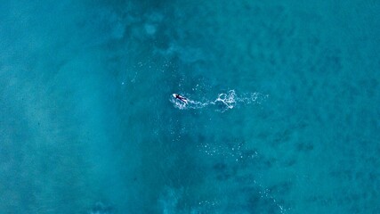 Surfer preparing to ride some waves, Cornwall., UK