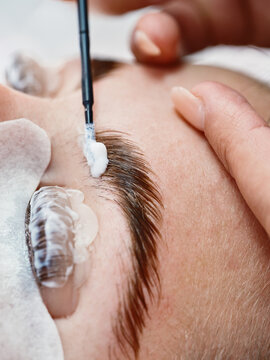 Cosmetician doing eyebrow lamination procedure
