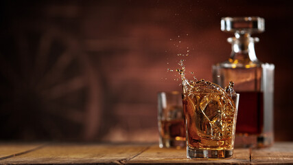 Freeze motion of ice cube falling into whisky shot