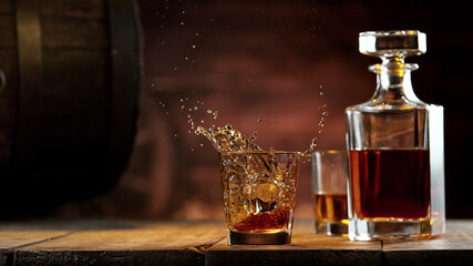 Freeze motion of ice cube falling into whisky shot