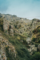 Unrecognized person doing slackline in the mountains