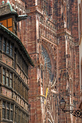 Obraz premium STRASBOURG, FRANCE, June 23, 2021 : Strasbourg Cathedral and Kammerzell house facade, an old and traditionnal architectural example of Strasbourg city houses.