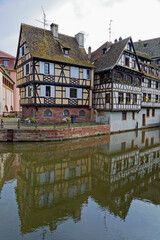 Fototapeta na wymiar STRASBOURG, FRANCE, June 23, 2021 : At Petite France, River Ill splits up into number of channels, home in the Middle Ages to the city's tanners, and a main tourist attraction.