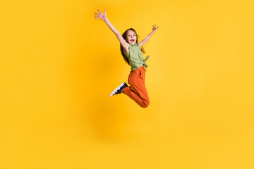 Full length body size photo little girl jumping up cheerful isolated vibrant yellow color background