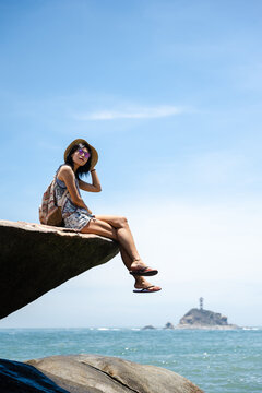 Beautiful Asian girl enjoying the seaside in sunny summer's day
