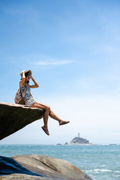 Beautiful Asian girl enjoying the seaside in sunny summer's day