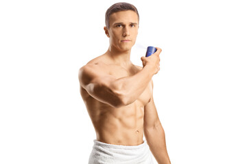Fototapeta premium Shirtless young man spraying a perfume