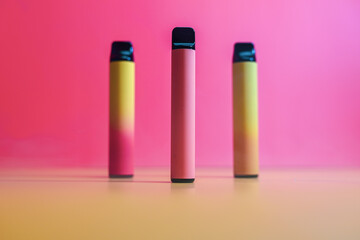 three vape electronic cigarettes on a red background