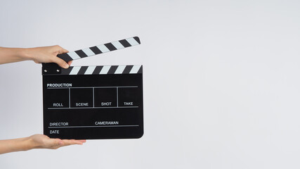 Fototapeta na wymiar Hands is holding black Clapperboard or movie slate. it use in video production ,film, cinema industry on white background.