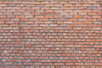 Light red brick wall. Old cracked brick, grunge texture background.