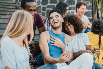 Young people having fun together with smartphone outdoor in the city - Focus on gay man face