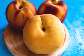 Close-up of some ripe organic peaches, with their velvet skin and beautiful colors.