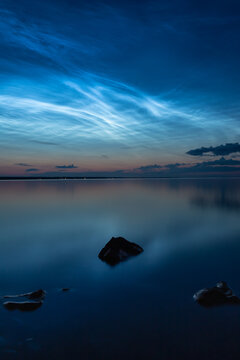 Night shining clouds (noctilucent clouds) over lake "Vänern" in Sweden.