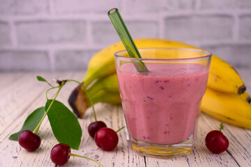 A glass of cherry banana smoothie. Healthy organic food.