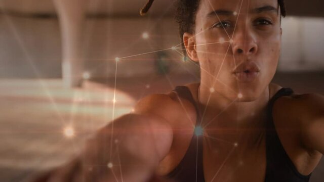 Glowing network of connections against african american fit woman working out