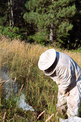 Beekeeper preparing his equipment. Copy space.