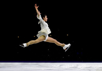 Mid air split jump performed by a professional ice skater