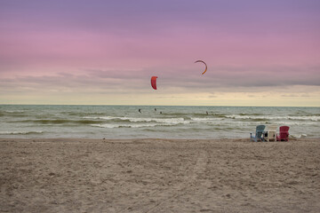 Obraz premium kitesurfing on beach with sunset