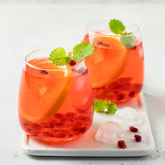 Iced tea, pomegranate citrus drink in glasses. Space for text.