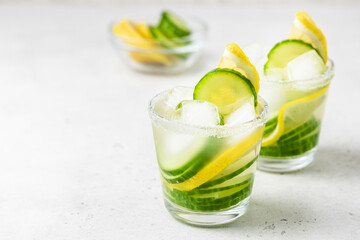 Infused water lemon cucumber summer drinks. Space for text.
