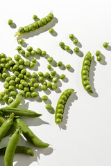 green peas and pods on a white background