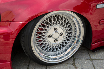 Modern car wheel with a light alloy disc. Low chassis.