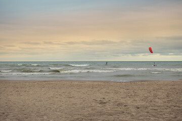 kitesurfing on beach with sunset