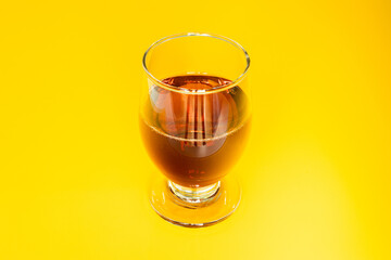 A Glass of Red Wine on a Yellow Background