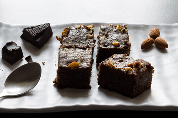 Dark chocolate almond brownies.Dessert topped with nuts and cocoa.Healthy homemade cake is moist, fudgy and has rich texture.
