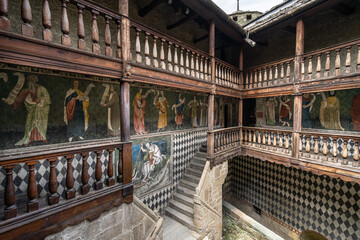 Fototapeta na wymiar Inner courtyard of Fenis Castle with medieval frescoes decorating the walls, Aosta Valley, Italy