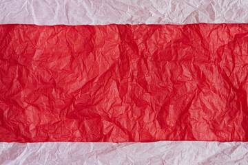 White crumpled paper background. Red paper tape for text.