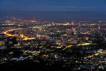 Fototapeta premium Day to night transition,Tourist landmarks doi Suthep viewpoint, Chiang Mai, Thailand, Asia region after sunset, Starlight from the city at night scape.