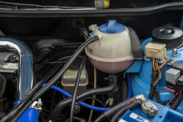 Open hood of vintage car. Old motor and parts after renovation