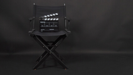 Clapper board or movie slate with director chair use in video production and cinema industry.It is...