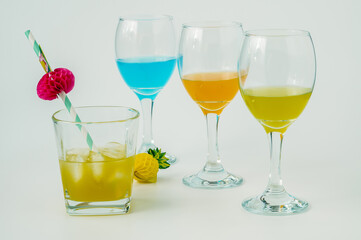 Wine glasses with yellow, blue and orange wine