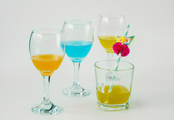 Wine glasses with yellow, blue and orange wine