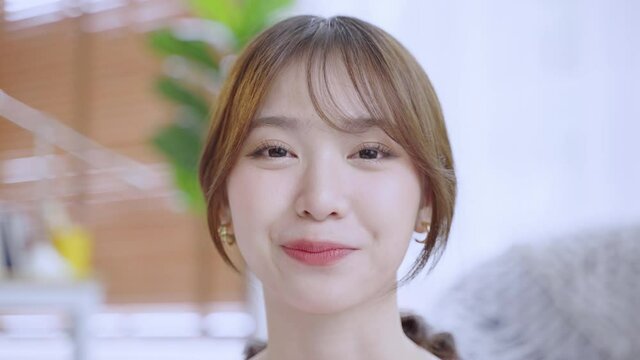 Asian woman with braces smiling until she sees wearing braces, beauty concept
