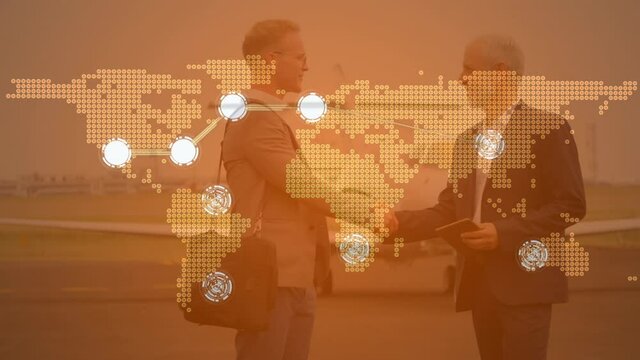 Connecting dots over world map against two caucasian businessmen shaking hands at airport runway
